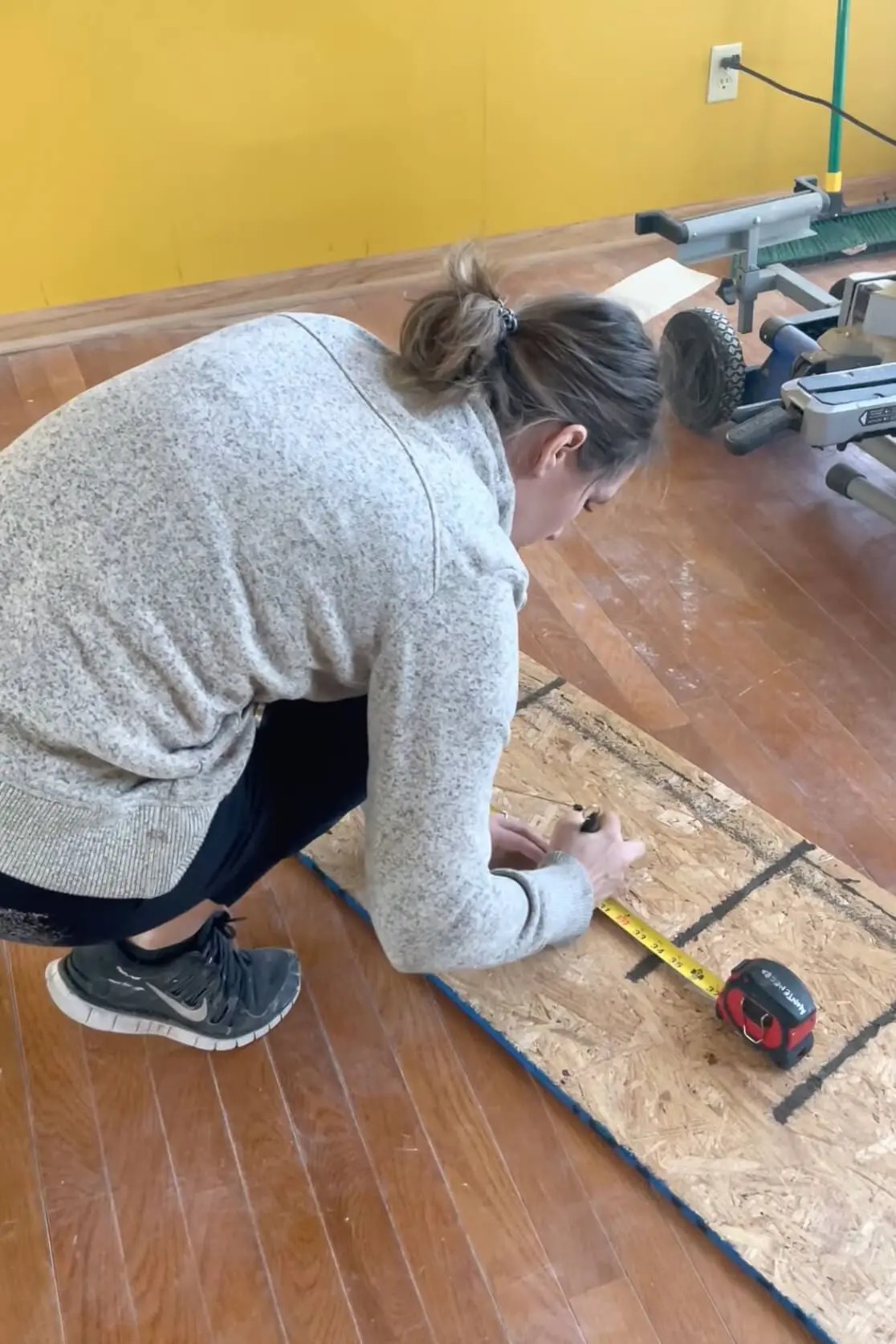 Using a miter saw to cut wood to make an arched doorway.